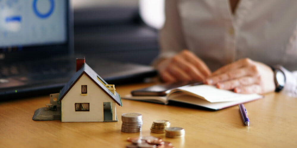 Small Home Model woith Coins on the Table