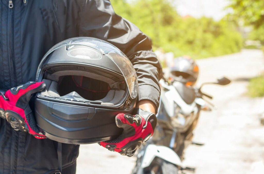 Man holding motorcycle helmet