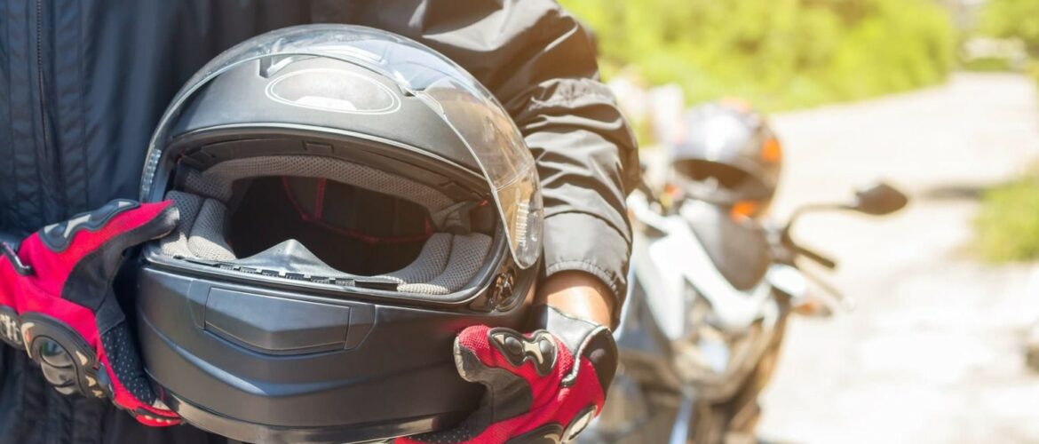 Man holding motorcycle helmet