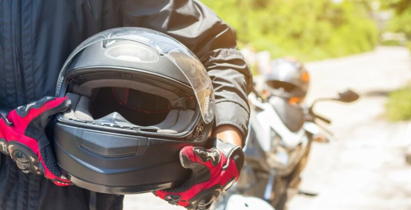 Man holding motorcycle helmet