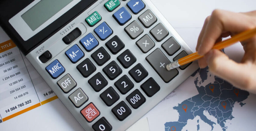 human using calculator with a pencil