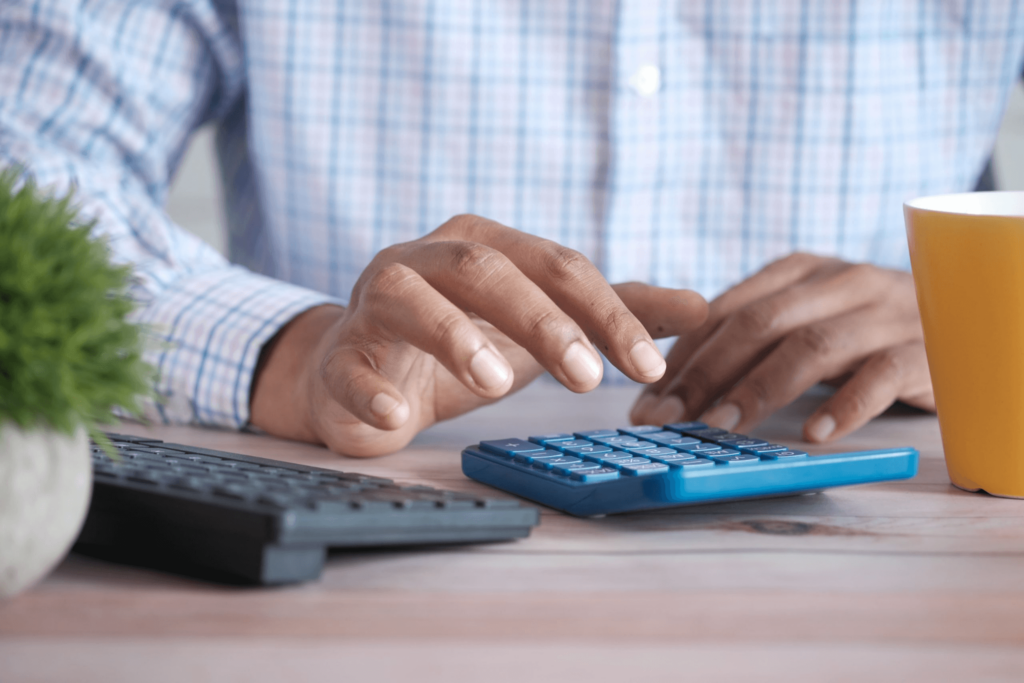 brown man using a calculator