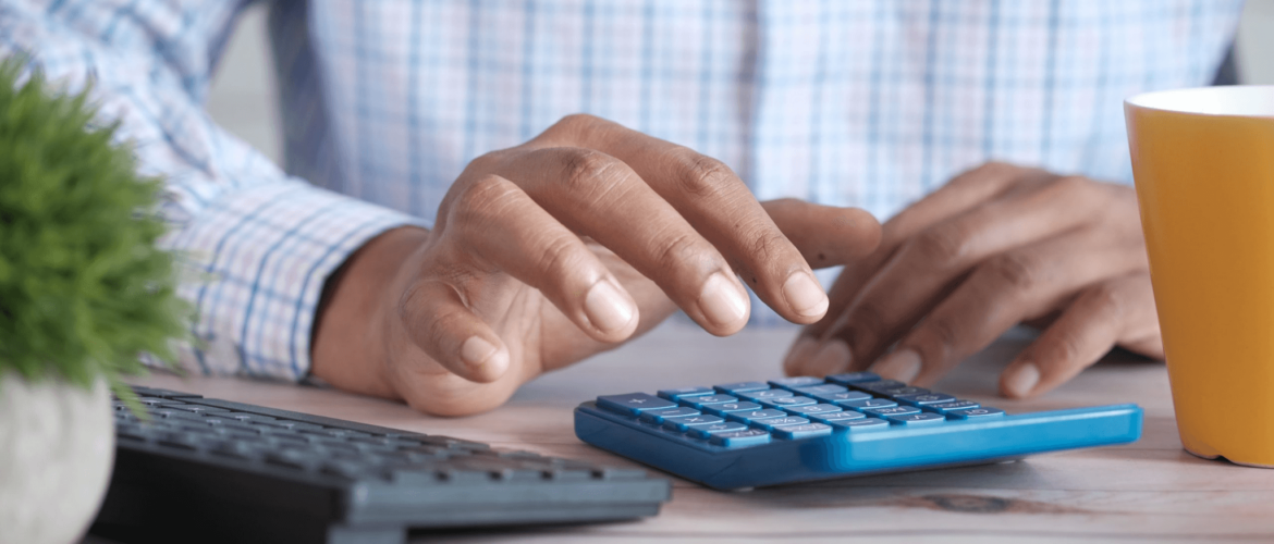 brown man using a calculator