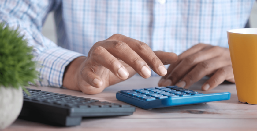 brown man using a calculator