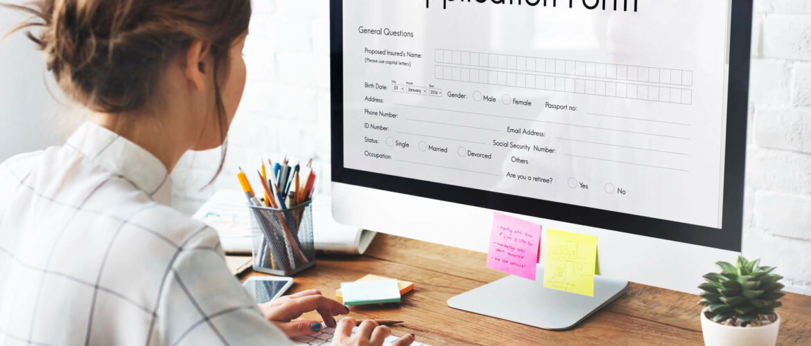 Woman sitting on a desk filling loan application form